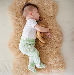 Image showing Baby, sleeping and dummy with relax in home for healthy development, growth and tired with top view. Child, rest and pacifier in mouth with nap, dreaming and wellness in nursery of house or apartment