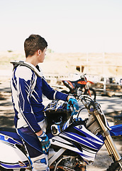 Image showing Motorcycle, extreme sport and man for race on trail for competition, vision or games with speed. Racer, motorbike and thinking for contest, motor cross and fast transportation with sunshine in desert