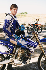 Image showing Motorbike, extreme sport and portrait for man on trail for competition, race and games with speed. Person, motorcycle and pride for contest, motor cross or fast transportation with sunshine in desert