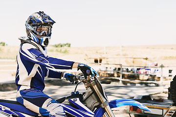 Image showing Dirtbike, extreme sport and portrait for man in helmet for competition, race and games with safety. Person, motorcycle and outdoor for contest, motor cross and fast transport with speed in desert