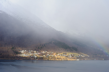 Image showing Misty seaside village at the foot of a mountain on a cloudy day