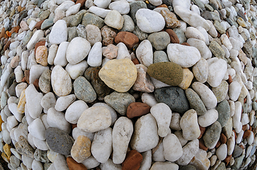 Image showing Multicolored pebbles arranged in an intricate circular pattern o