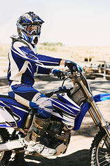 Image showing Motorcycle, extreme sport and portrait for person on trail for competition, race or games with speed. Racer, motorbike and helmet for contest, motor cross and fast transport with sunshine in desert