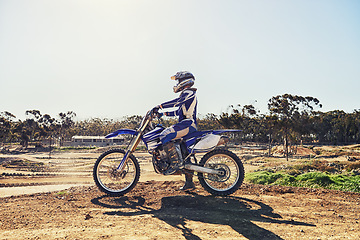 Image showing Man, motorbike and outdoor on trail for extreme sport in profile on dirt, path or countryside in summer. Person, motorcycle and gravel on road with vehicle, machine or fast transport in competition