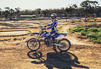 Image showing Man, motorbike and outdoor on trail for portrait with helmet on dirt, path and countryside in summer. Person, motorcycle and gravel on road with vehicle, machine and fast transport in competition