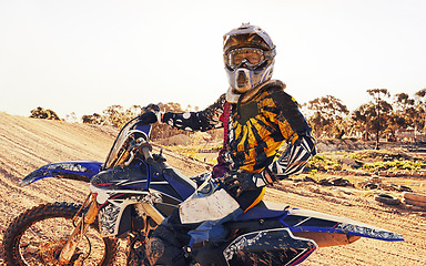 Image showing Helmet, race and man on dirt bike in desert with adventure, adrenaline or speed in competition, Extreme sport, trick and athlete on off road motorcycle for challenge, power or danger on action course