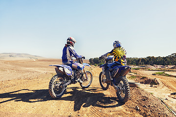 Image showing Rear view, racer or people on motorcycle outdoor on dirt road with relax after driving, challenge and competition. Motocross, motorbike and dirtbike driver with helmet on offroad and path for racing