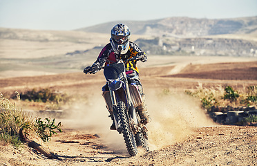 Image showing Person, professional motorcyclist and dirt track for race, extreme sports or outdoor competition. Expert rider on motorbike or scrambler for sand course, challenge or off road rally in nature dunes