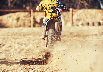 Image showing Person, motorcyclist and dust with dirt bike on track for race, extreme sports or outdoor competition. Rear view of expert rider on motorbike, scrambler or sand course for off road rally challenge