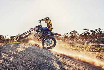 Image showing Dust, race and man on dirt bike in desert with adventure, adrenaline and speed in competition, Extreme sport, trick and athlete on off road motorcycle for challenge, power or danger on action course