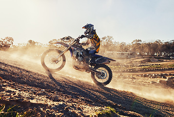 Image showing Hill, race and man on dirt bike in desert with adventure, adrenaline and speed in competition, Extreme sport, dust and athlete on off road motorcycle for challenge, power or danger on action course