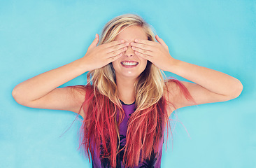 Image showing Smile, woman or hide face in studio for surprise or excited for secret announcement by blue background. Female, student and peek a boo for scholarship or competition and education in review or mockup