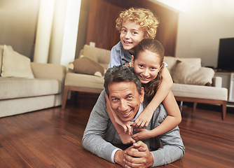 Image showing Portrait, home and grandfather on the floor, grandchildren and happiness with stack and vacation. Face, apartment and elderly man with grandkids or bonding together with fun and playing with siblings