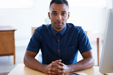 Image showing Business, portrait and confident black man at desk in workplace, office or startup company for job of employee. Face, table and serious entrepreneur, creative and designer working in South Africa