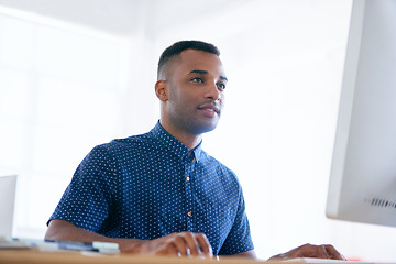 Image showing Computer, typing and man with research in office for creative project on internet by desk. Technology, career and professional male designer working online with desktop for job in modern workplace.