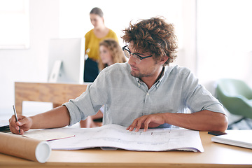 Image showing Blueprint, desk and architect with paperwork in office for brainstorming, writing and building design. Man, workplace and floor plan on table with thinking for idea, vision and property development