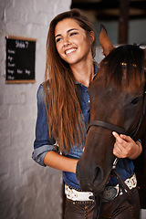 Image showing Woman, face and happiness with horse in stable for bonding, sports training and recreation in Texas. Stallion, person and animal on farm or barn with smile for healthy livestock, hobby and pet care