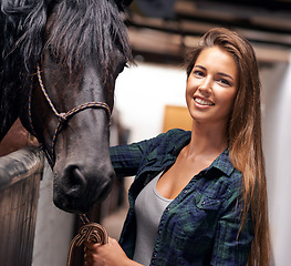 Image showing Woman, portrait and smile with horse in stable for bonding, sports training and recreation in Texas. Stallion, cowgirl and animal or face in barn with smile for healthy livestock, hobby and pet care