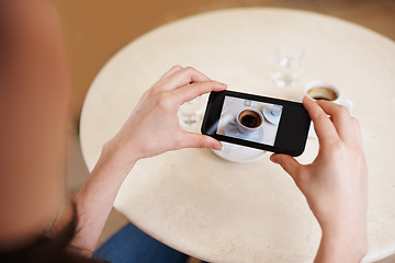 Image showing Hands, smartphone screen and top view photography of coffee, tea or espresso for social media, content or blogging. Closeup, person and cellphone with hot beverage cup at restaurant, cafe and table