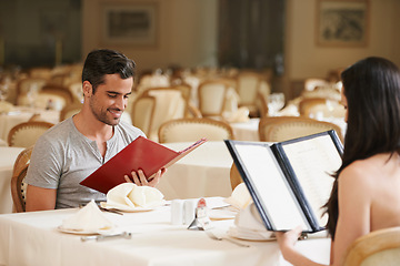 Image showing Couple, restaurant and menu for selection, bonding and romantic date on valentines day. People, love and meal at cafe or lunch choice for anniversary celebration, cuisine and together at bistro