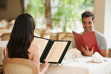 Image showing Couple, restaurant and menu for food choice, fine dining and bonding on valentines day. People, love and romance at cafe or lunch selection for anniversary date, gourmet cuisine and happy at bistro