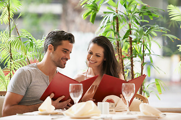 Image showing Couple, restaurant and reading a menu on date, fine dining and bonding on valentines day. People, love and romance at cafe or lunch choice for anniversary celebration, cuisine and happy at bistro