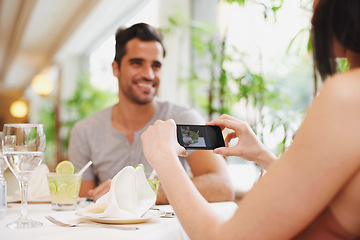 Image showing Restaurant, man and woman taking picture, food and lunch with digital app and social media. People, cafe and couple with smartphone or photograph with influencer and love with Valentines day or happy