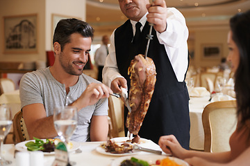 Image showing Couple, server and service for dinner in restaurant with meat, happiness and fine dining for anniversary or honeymoon. Man, woman and employee with steak on skewer, healthy meal and table in London