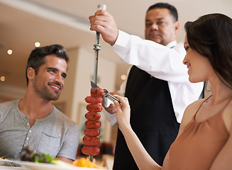 Image showing Food, date and romance with couple in restaurant together for celebration or eating espetada. Love, meat or dinner with happy young man and woman in fine dining hospitality establishment for service