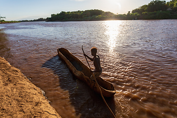 Image showing Ferryman on wooden coarse boat on mystical Omo river, Ethiopia