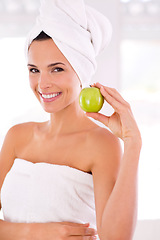 Image showing Happy woman, portrait and beauty with apple for nutrition, diet or healthy vitamins at home. Face of young female person or model with smile and organic green fruit for natural skincare or wellness