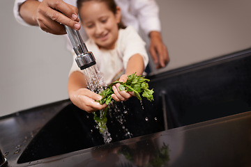 Image showing Child, washing and kitchen sink with salad, food and cleaning for cooking in a home. Water, health and happy girl with herb and helping for lunch and meal together with youth and learning hygiene