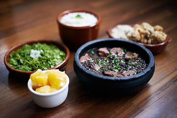 Image showing Black beans, food and chilli with vegetables and Mediterranean cooking, vegan and nutrition for diet. Health, bowl and dish at a restaurant or diner with organic, salad and table with Mexican dinner