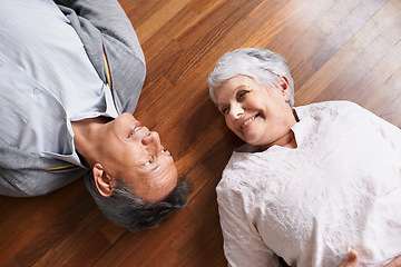 Image showing Smile, senior or happy couple on floor to relax in home living room for bonding or support in retirement. Above, old people or man lying down by an elderly woman for trust, peace or care in marriage