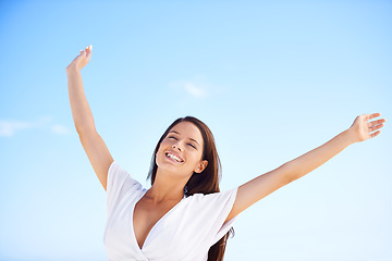 Image showing Blue sky, smile and woman on holiday with freedom, happy adventure and sunshine in Greece. Summer, sun and face of girl stretching arms for energy, wellness and outdoor travel vacation in nature.