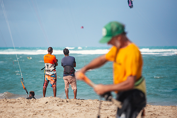 Image showing Active sporty people enjoying kitesurfing holidays and activities on perfect sunny day on Cabarete tropical sandy beach in Dominican Republic.