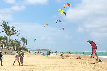 Image showing Crowd of active sporty people enjoying kitesurfing holidays and activities on perfect sunny day on Cabarete tropical sandy beach in Dominican Republic.