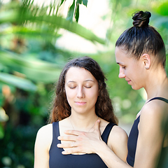 Image showing Yoga concept, meditation and sound therapy. Beautiful young girl at yoga session with her yoga and meditation teacher at tropical yoga retrear