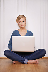 Image showing Laptop, smile and portrait of woman on floor working on freelance project for remote job. Happy, technology and young female person sitting on ground with computer for online research at home.