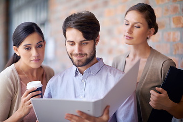 Image showing Portfolio, teamwork and employees talking in office for planning, partnership or conversation. Man, women or people in group meeting for business, collaboration and speaking of file or reading folder