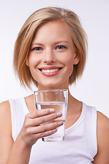 Image showing Drinking water, portrait and happy woman for wellness, nutrition and hydration in studio against white background. Detox, female person or model and healthy lifestyle for diet and weight loss.