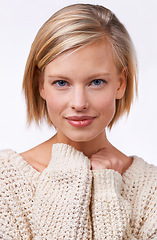 Image showing Woman, portrait and cozy in studio with jersey, fashion and winter knitwear for comfort and confident. Female person, style and sweater for face, white background and smile for clothes and happiness