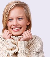 Image showing Female person, smile and cozy in studio with jersey, fashion and winter knitwear for comfort and confident. Woman, style and sweater for face, white background and portrait for beauty and happiness