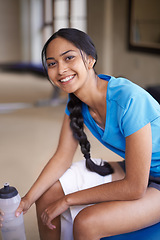 Image showing Woman, portrait and water bottle at gym, relax and hydrate on break from workout at club. Female person, rest and happy for training or exercise, smile and liquid for fitness and nutrition for health