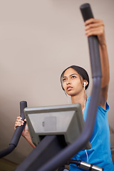 Image showing Woman, earphones and audio for cycling, bike and stationary machine for workout at club. Female person, cardio and inspirational podcast for motivation, playlist and equipment for fitness and health