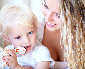 Image showing Smile, mother and baby child with toy, playing and family bonding together for development in home. Mom, toddler and kid with giraffe animal for game, happy and having fun with parent for learning