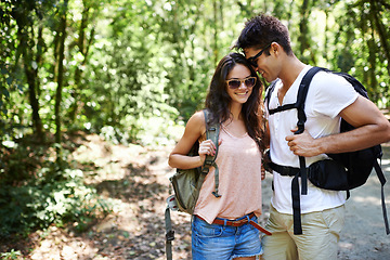 Image showing Travel, love or happy couple hiking in nature or wilderness on a fun trekking adventure trip. Man, woman or romantic people in natural park or woods with care, peace or wellness on holiday vacation