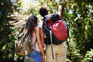 Image showing Hiking, pointing and back of couple in nature for adventure, love and explore outdoors. Forest, travel and man and woman with view on holiday, vacation and trekking for wellness, fitness or health