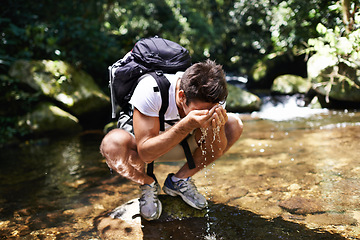 Image showing Water, splash or man hiking in nature or wilderness for cleaning face or trekking adventure. River, relax or male hiker on break walking in a natural park or woods for exercise or wellness by a lake