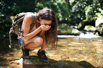 Image showing Drinking water, nature and woman by river in forest for thirst on adventure, trekking and explore outdoors. Travel, hiking and person by lake for health and wellness on holiday, vacation and journey